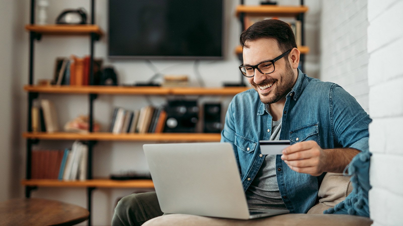 Man smiling in front of his laptop